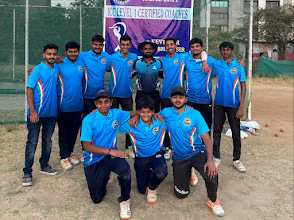 Academy team in blue jerseys posing with their Level 1 certified coaches