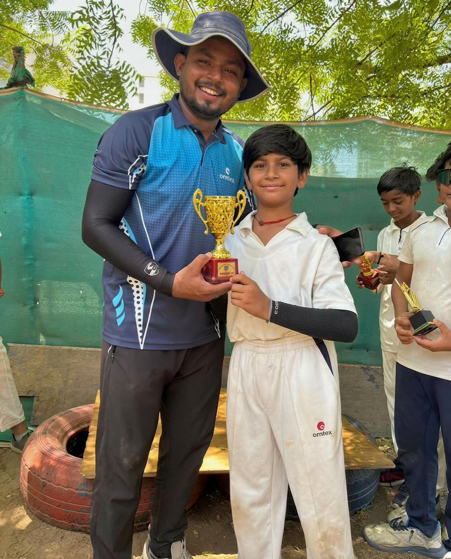 Coach Shubham Kanojiya with a young Desire Cricket Academy student holding a winners trophy